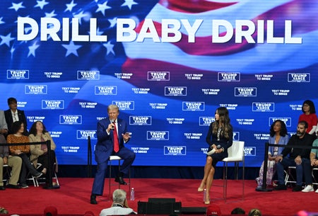 President-elect Donald Trump speaks at a campaign town hall on Oct. 14, 2024, in Oaks, Pennsylvania, as moderator South Dakota Gov. Kristi Noem (R) listens.