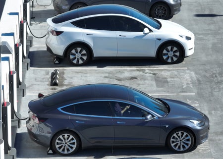 Two electric cars at a charging station