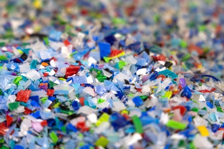 Multi-colored plastic flakes at a recycling center.