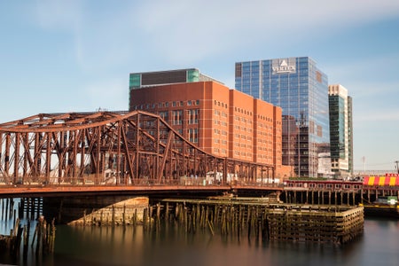 Image of a bridge in a city, with the Vertex building in the distance