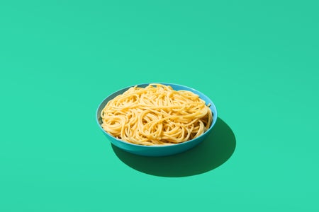 Photo of spaghetti in a bowl green color background