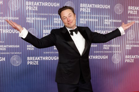 Elon Musk with arms in a wide shrug