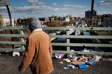 Man walking on littered overpass