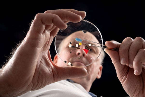 Microplastics displayed in glass petri dish held by researcher