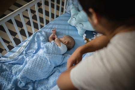 Close up of young father who is taking care of infant