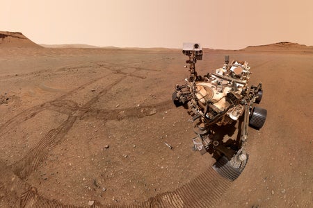 A selfie of NASA's Perseverance Mars rover with sample tubes it deposited at a sample depot it is creating within an area of Jezero Crater nicknamed "Three Forks." The ninth tube dropped during the construction of the depot, containing the sample the science team refers to as "Atsah," can be seen in front of the rover. Other sample tubes are visible in the background.