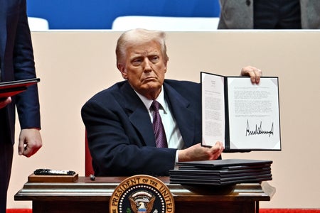 US President Donald Trump signs executive orders.