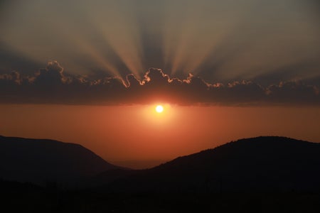 Scenic view of silhouette of mountains against sky during sunset