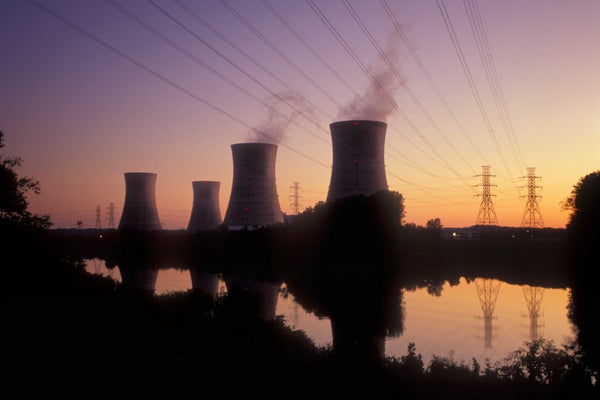 The four cooling towers at Three Mile Island Nuclear Power Plant and their reflections in the calm water of the Susquehanna River in the foreground are seen at sunset near Middletown, Pennsylvania