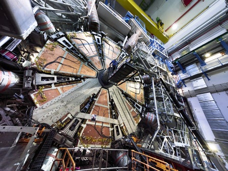 The 100-tonne wheel is lowered 80 meters underground in the ATLAS cavern at the Large Hadron Collider level.