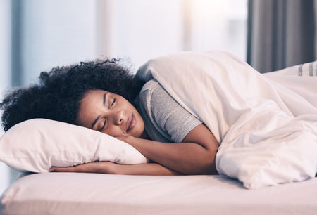 Woman sleeping in sheets