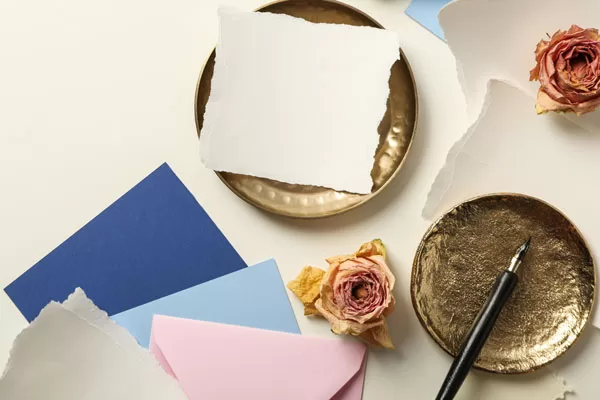 Pieces of paper, roses and golden plates